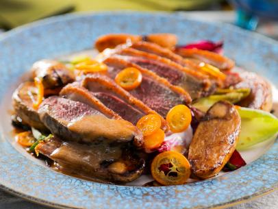 Nyesha Arrington’s Wood-Fired Duck Breast with Chicories and Miso Kumquat Dressing, as seen on Guy's Ranch Kitchen Season 5.