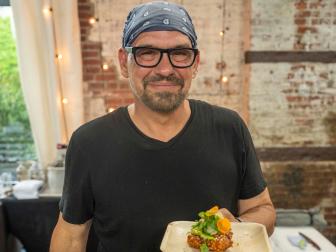 Chef Michael Symon with his Asian fried chicken dish, as seen on Throwdown with Michael Symon, Season 1.