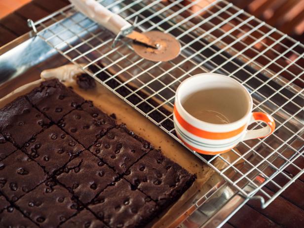 Homemade chocolate brownie with chocolate chip and cup on grille