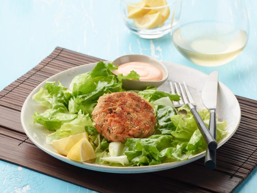 Food Network Kitchen's Salmon Cakes Over A Mixed Green Salad, as seen on Food Network.