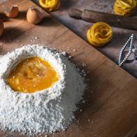 Pasta recipe handmade preparation with eggs and flour with ingredients and tools as rolling pin homemade