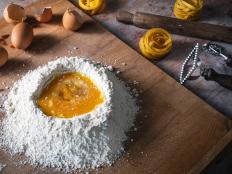 Pasta recipe handmade preparation with eggs and flour with ingredients and tools as rolling pin homemade