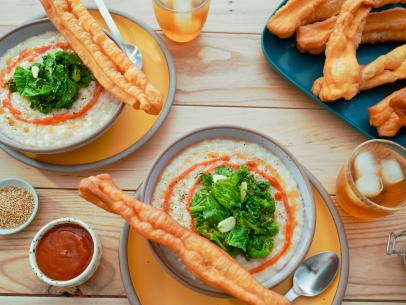 Beauty shot of Molly Yeh's Congee with Sautéed Greens and Chinese Crullers