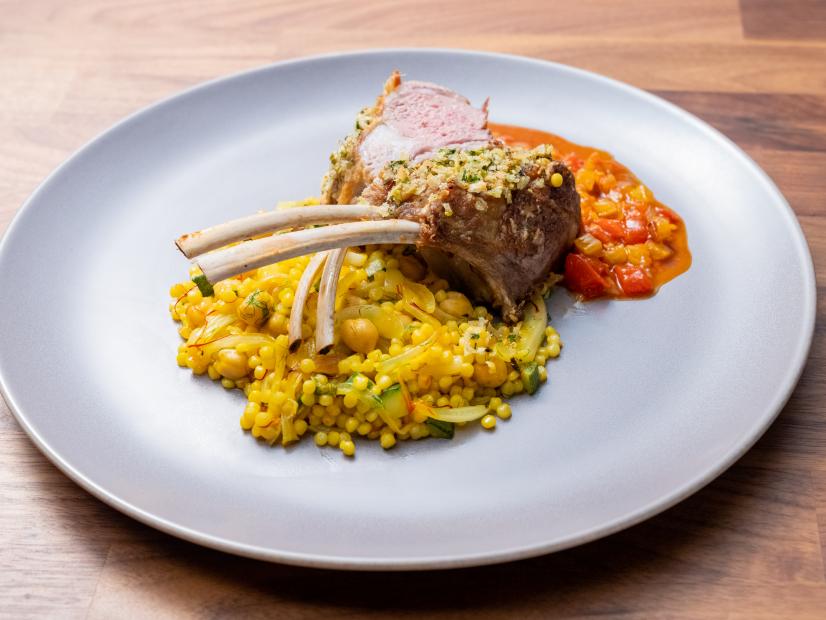 The Main Dish from the Red Team Demo, featuring garlic rosemary and parsley crusted rack of lamb with harissa sauce, Israeli couscous and sauteed spinach, as seen on Worst Cooks In America, Season 24.