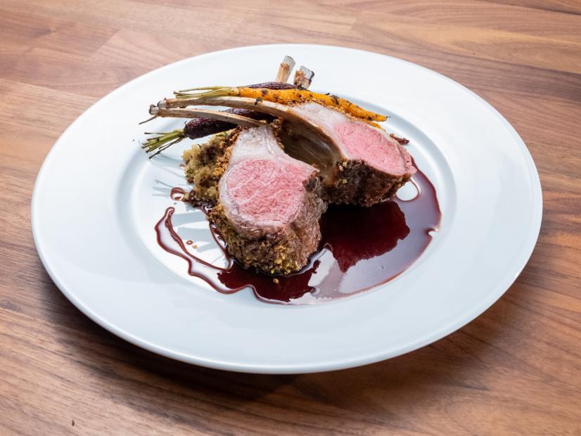 The Main Dish from the Blue Team Demo, featuring couscous and roasted baby carrots with Baharat spice with parsley, pine nut and panko rack of lamb, as seen on Worst Cooks In America, Season 24.