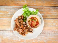 Roasted pork Chitterlings with chilli sauce spicy / entrails intestines part of pork asian thai food