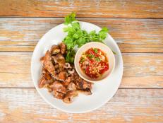 Roasted pork Chitterlings with chilli sauce spicy / entrails intestines part of pork asian thai food