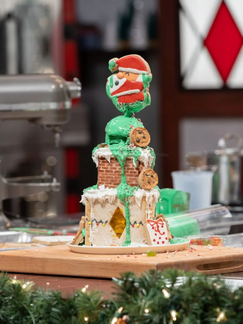 Baker Megan Nunez's R2 dish: DESIGN: Santa's Busted Toy Bag.COOKIE DOUGH 1: Orange Cinnamon Clove Cookie.w/Vanilla Royal Icing.COOKIE DOUGH 2: Lemon White Chocolate Coconut Macadamia Cookie w/Vanilla Royal Icing.INGREDIENT: Coconut,.as seen on Christmas Cookie Challenge, Season 5