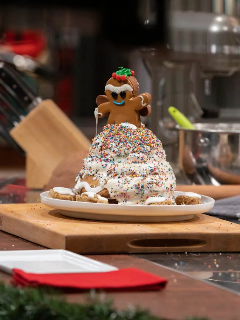 Baker Ernest Strickland's R2 dish, DESIGN: Gingerbead Christmas Tradition.COOKIE DOUGH 1: Carrot Cinnamon Roll Cookie w/Cream Cheese Royal Icing.COOKIE DOUGH 2: Literally Hot Chocolate Cookie w/Cream Cheese Royal Icing.COOKIE DOUGH 3: Banana Pudding Cookie INGREDIENT: Carrot, as seen on Christmas Cookie Challenge, Season 5