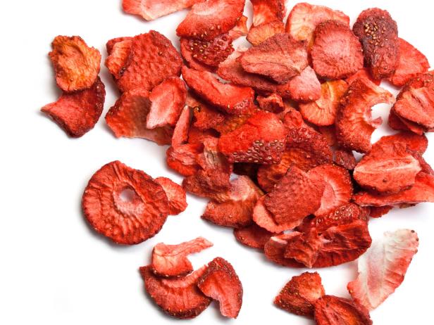 Sliced dried strawberries isolated on white