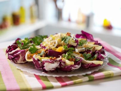 Alex Guarnaschelli makes her Endive Salad with Candied Walnuts, Orange Caramel Dressing, and Blue Cheese, as seen on The Kitchen, season 30.