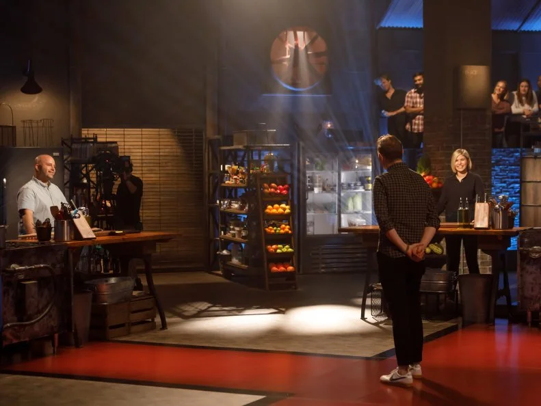 Chef Bobby Flay explains the rules of Round 1 to contenders Sayat and Laura Ozyilmaz, as seen on Beat Bobby Flay, Season 29.