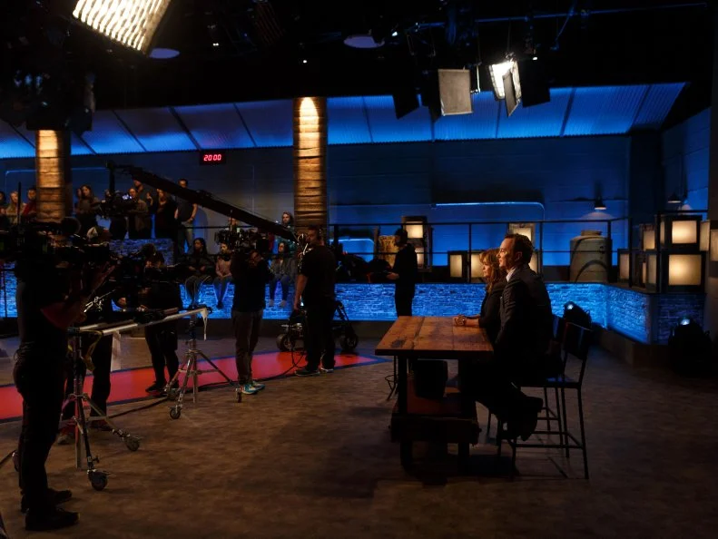 Behind the scenes of co-hosts Valerie Bertinelli and Clinton Kelly sitting at the table, as seen on Beat Bobby Flay, Season 22.