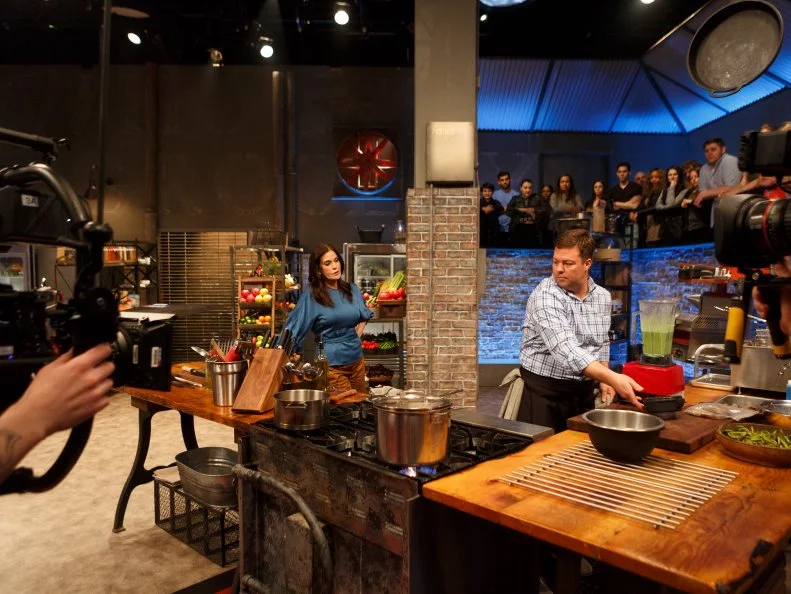 Behind the scenes of co-host Teri Hatcher checking in with contender Geoff Lazlo during Round 1, as seen on Beat Bobby Flay, Season 23.