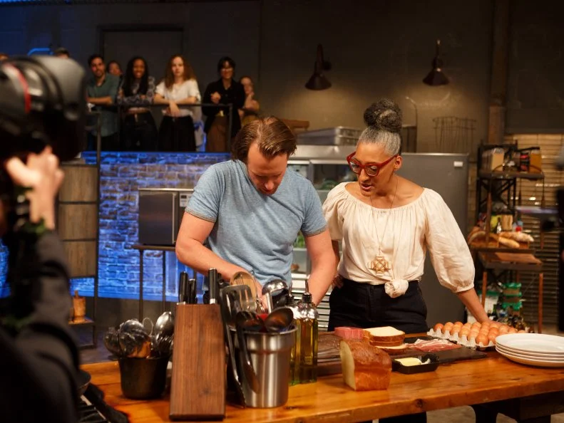 Co-host Carla Hall checks in with contender Justin Hunt, as seen on Beat Bobby Flay, Season 24.