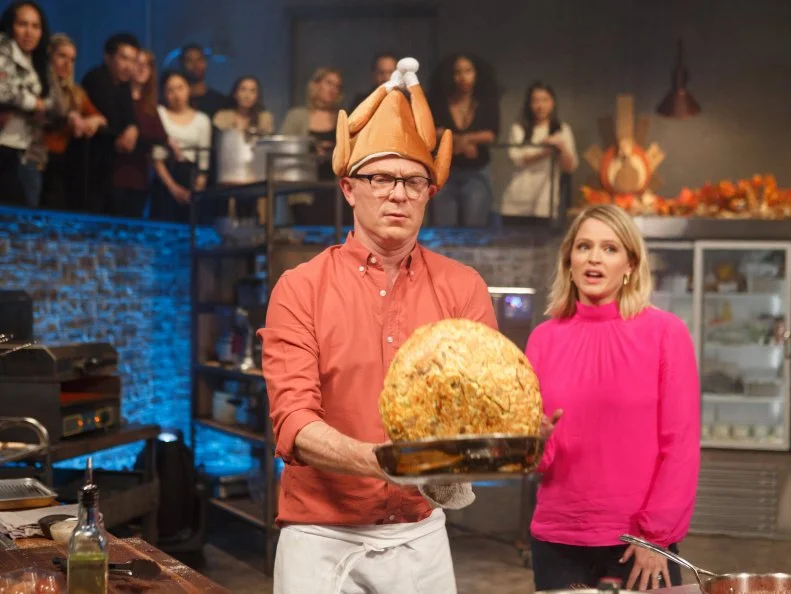 Chef Bobby Flay flips tortilla stuffing, as seen on Beat Bobby Flay, Season 18.