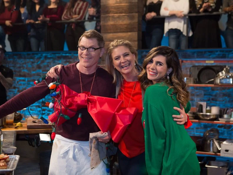 Co-Hosts Jamie-Lynn Sigler and Amanda Freitag wrap up chef Bobby Flay, as seen on Beat Bobby Flay, Season 18.