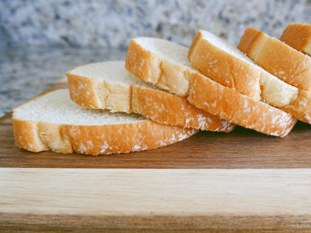Close-up of slices of bread on cutting board in kitchen