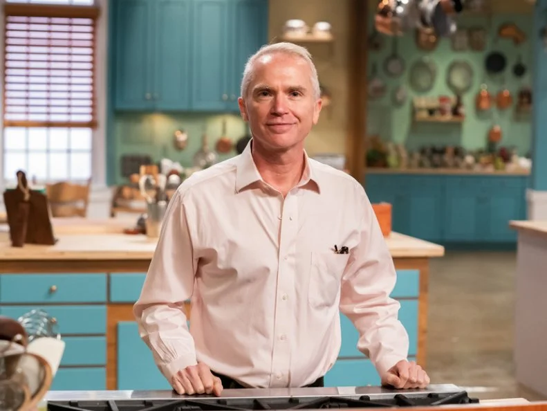 Contestant Bill Borman poses behind his station, as seen on Julia Child Challenge, Season 1