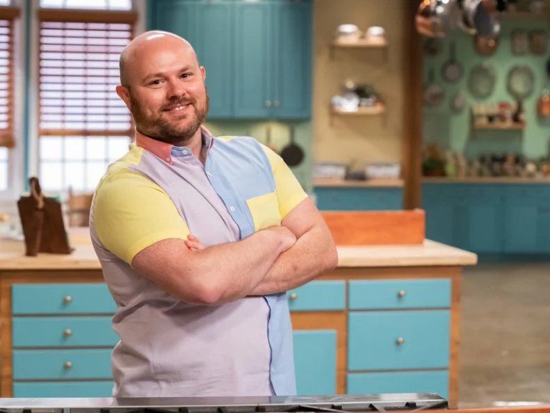 Contestant Dustin Rennells poses behind his station, as seen on Julia Child Challenge, Season 1