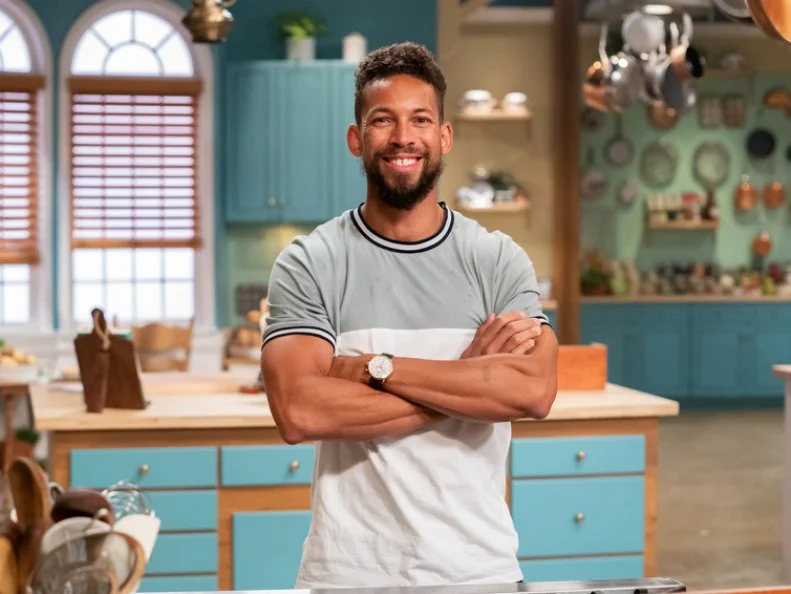Contestant Dustin Hogue poses behind his station, as seen on The Julia Child Challenge, Season 1.