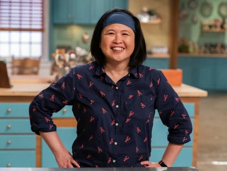 Contestant Elena Ross-Salonga poses behind her station, as seen on Julia Child Challenge, Season 1
