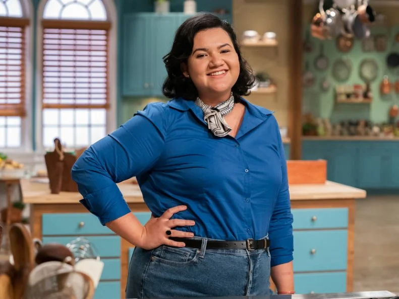 Contestant Jaine Mackievitz poses behind her station, as seen on Julia Child Challenge, Season 1