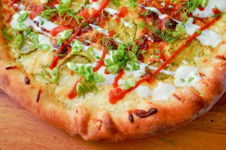 Beauty shot of Molly Yeh's Stuffed Crust Purim Pickle Pizza, as seen on Girl Meets Farm, season 10.