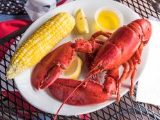 white plate of delicious lobster with indian corn