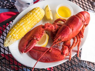 https://food.fnr.sndimg.com/content/dam/images/food/fullset/2022/02/7/lobster-on-plate-with-corn-draw-butter.jpg.rend.hgtvcom.406.305.suffix/1644272596541.jpeg