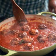 Preparing Meatballs with Tomato Sauce in a Pan