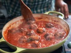Preparing Meatballs with Tomato Sauce in a Pan