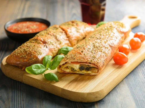 Pizza stromboli on a wooden background