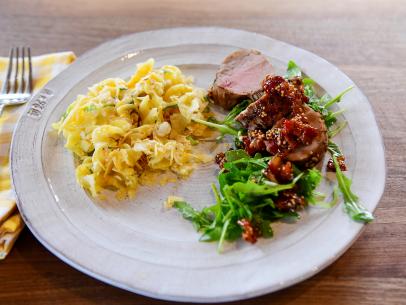 Close-up of Roasted Pork Tenderloin with Bacon Jam and Cheesy Crunchy Noodle Casserole, as seen on The Pioneer Woman, season 30.