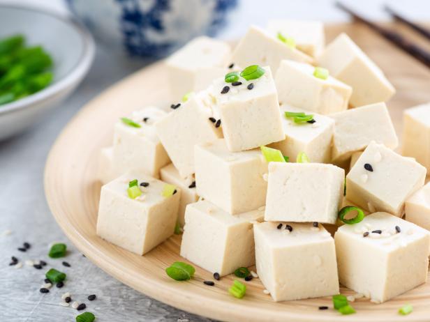 Tofu cubes on bamboo plate. Healthy asian food