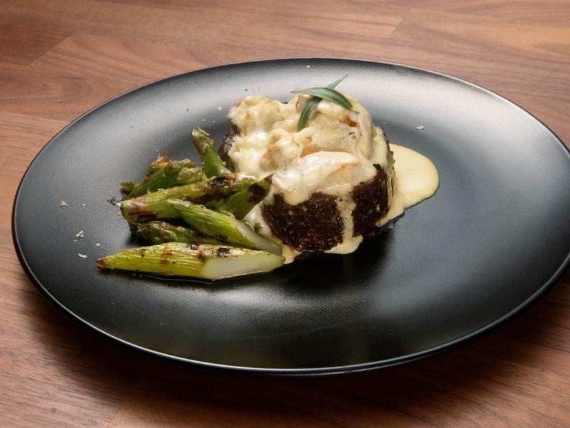 Jeff Mauro’s Steak Oscar with Stone Crab and Grilled Asparagus is displayed, as seen on Worst Cooks in America, Season 23.