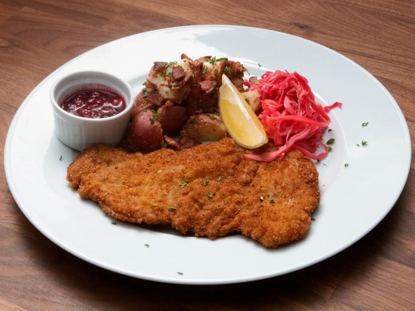 Jeff Mauro’s Pork Schnitzel with Warm German Potato Salad and Pickled Cabbage is displayed, as seen on Worst Cooks in America, Season 23.