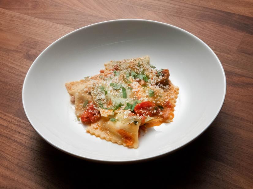 Anne Burrell’s Sausage and Ricotta Agnolotti with Burst Cherry Tomato and Pancetta Sauce is displayed, as seen on Worst Cooks in America, Season 23.
