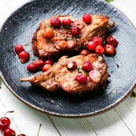 Pork chops on the bone roast in berry marinate.Meat in cherry wine sauce