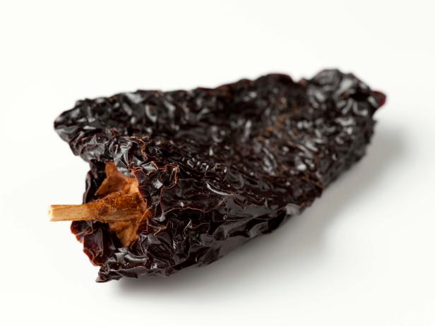 Chile Ancho are dried poblanos chilis and they're popular in Mexican cuisine, here they're photographed on a white background.