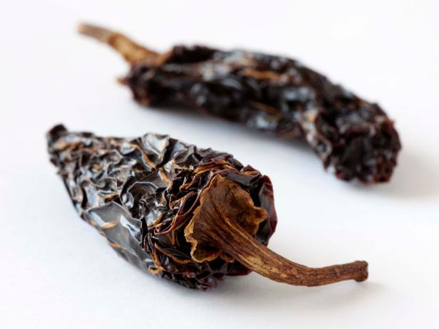 Dried chipotle chili pepper on a white background.