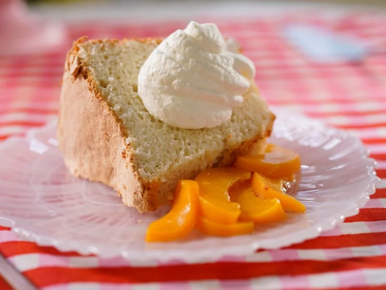 Katie Lee Biegel makes her Great Grandma Pearl’s Angel Food Cake with Peaches and Cream, as seen on The Kitchen, Season 30.