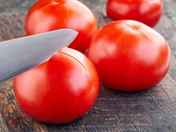 ripe tomatoes are prepared for blanching