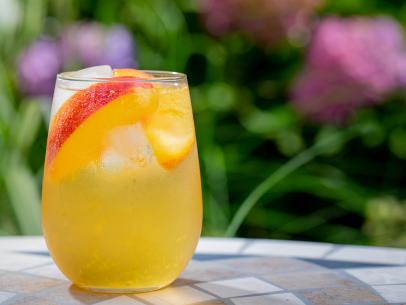 Host Michael Symon's Peach Sangria, as seen on Symon's Dinners Cooking Out, Season 3.