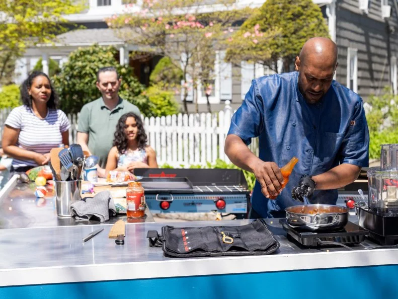 Chef Claude Lewis with the Tornetto Family during Round 1, as seen on Kitchen Crash, Season 2.