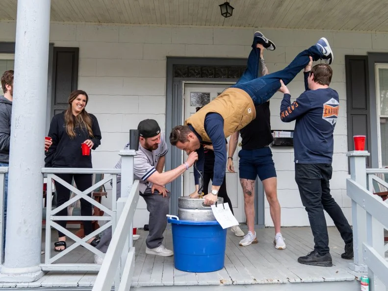 Host Jeff Mauro drinks from the Lemonade keg with the neighborhood, as seen on Kitchen Crash, Season 2.