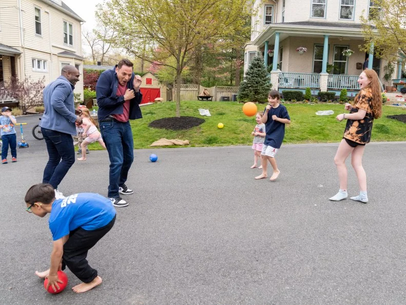 Host Jeff Mauro and Cliff Crooks play dodgeball with the neighborhood kids, as seen on Kitchen Crash, Season 2.