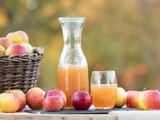 Fresh apple juice from apples in the fall after harvest, served on a table