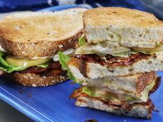 I love a BLT and my kicked-up version has all the fixin's, including four slices of bacon per sandwich! To make it over-the-top, I use my own homemade roasted garlic aioli and pickled green tomatoes instead of ripe red tomatoes for a little tang.