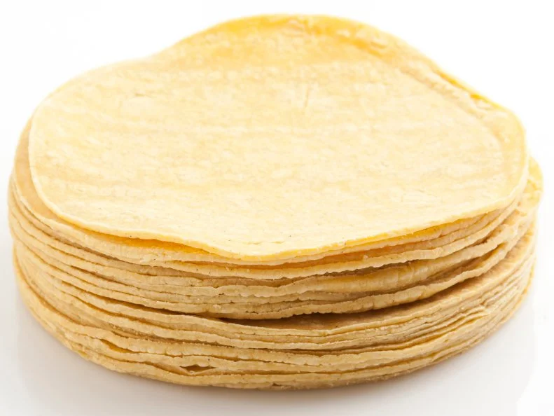 Stack of Plain yellow corn tortillas on white background